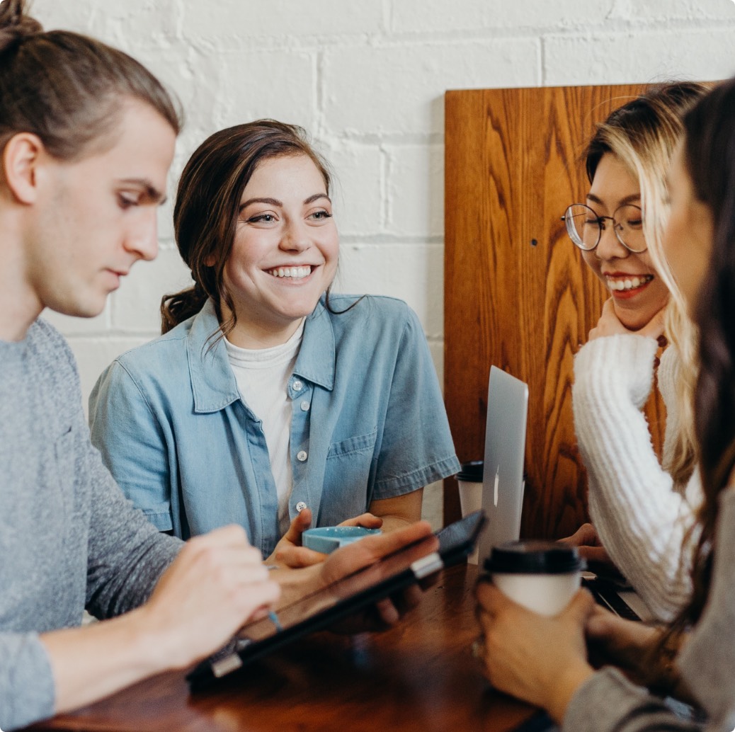 A man and three women chatting about the project